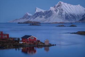blue background red cabin lofoten fjord