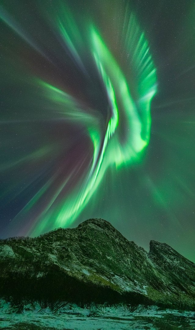 Use vertical composition for your Northern Lights images Instense Northern Lights over a mountain