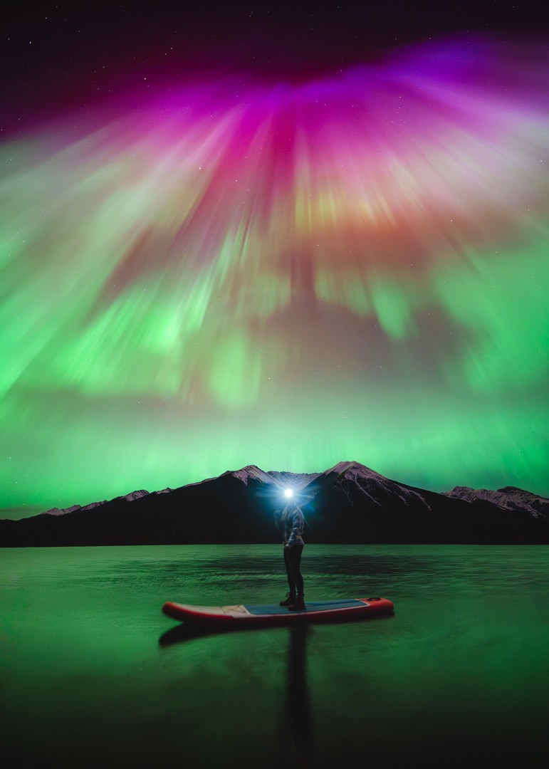 Paddling under the Northern Lights Person paddling under the northern lights