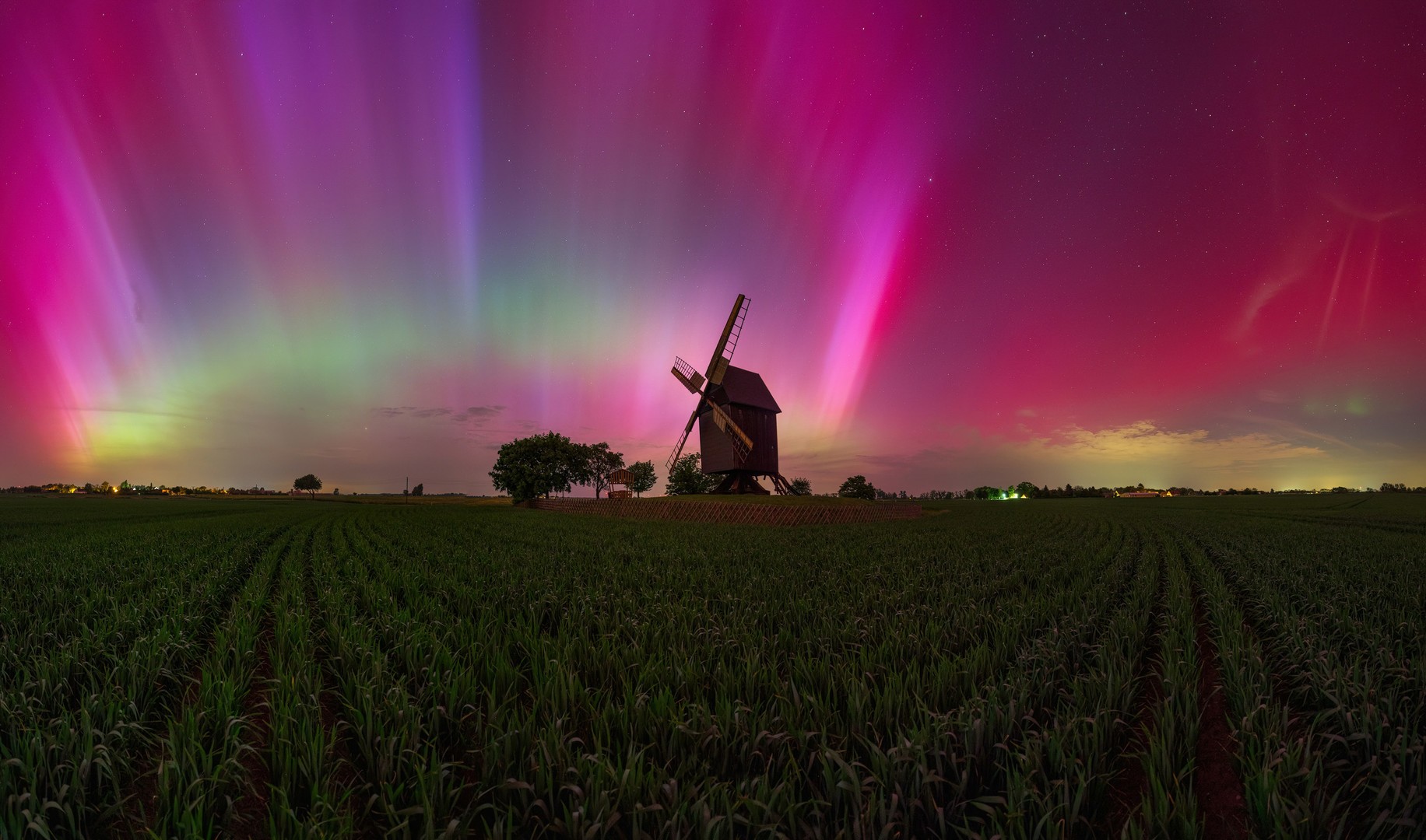 Northern Lights over a mill in Germany Northern lights cover the night sky over a mill in Germany
